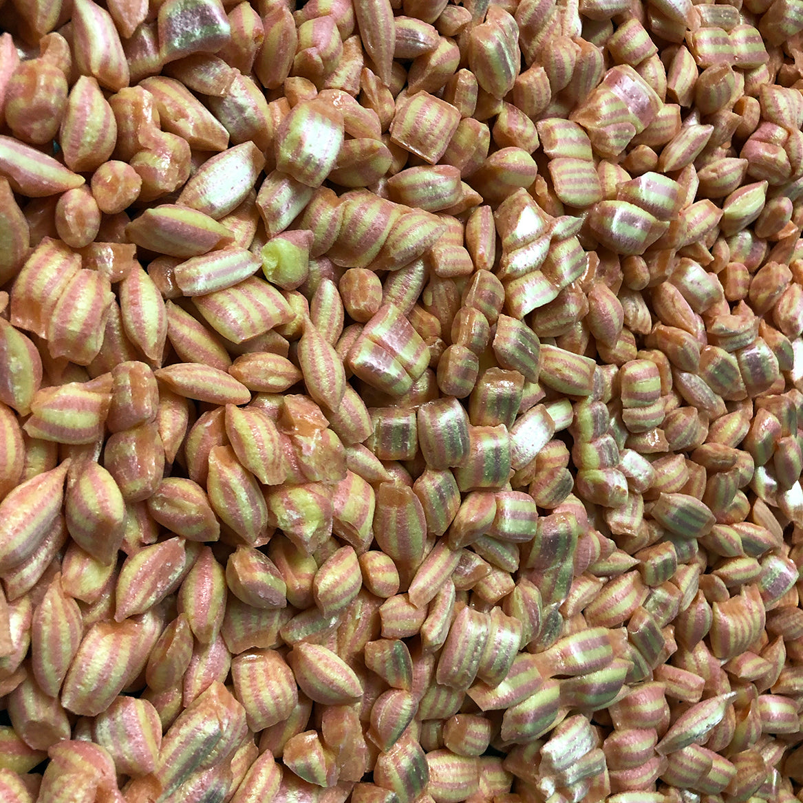 pieces of Sticky's strawberry and piña colada flavored Lava Fizz candy